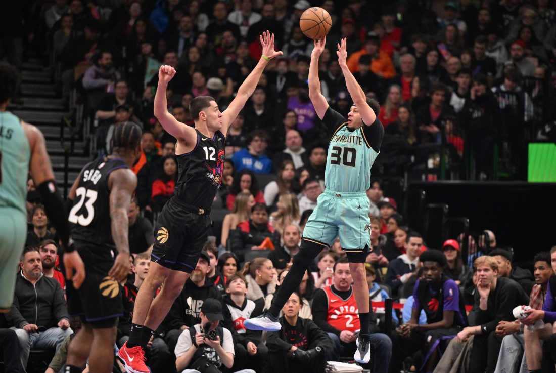 Mar 28, 2025; Toronto, Ontario, CAN; Charlotte Hornets guard Seth Curry (30) shoots the ball over Toronto Raptors forward Cole Swider (12) in the first half at Scotiabank Arena.