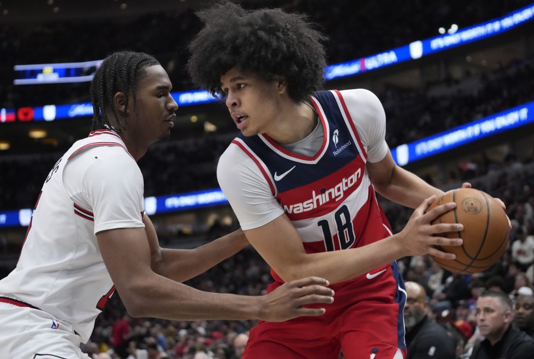 Apr 11, 2025; Chicago, Illinois, USA;Chicago Bulls forward Julian Phillips (15) defends Washington Wizards forward Kyshawn George (18) during the second half at United Center.