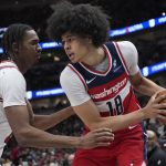 Apr 11, 2025; Chicago, Illinois, USA;Chicago Bulls forward Julian Phillips (15) defends Washington Wizards forward Kyshawn George (18) during the second half at United Center.