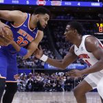 May 1, 2025; Detroit, Michigan, USA; New York Knicks center Karl-Anthony Towns (32) is defended by Detroit Pistons center Jalen Duren (0) in the first half during game six of first round for the 2024 NBA Playoffs at Little Caesars Arena.