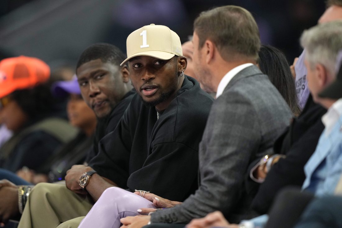 May 16, 2025; San Francisco, California, USA; Golden State Warriors forward Jonathan Kuminga (center left) talks with owner Joe Lacob (center right) during the second quarter of the game between the Golden State Valkyries and the Los Angeles Sparks at Chase Center. Mandatory Credit: Darren Yamashita-Imagn Images
