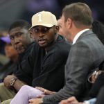 May 16, 2025; San Francisco, California, USA; Golden State Warriors forward Jonathan Kuminga (center left) talks with owner Joe Lacob (center right) during the second quarter of the game between the Golden State Valkyries and the Los Angeles Sparks at Chase Center. Mandatory Credit: Darren Yamashita-Imagn Images