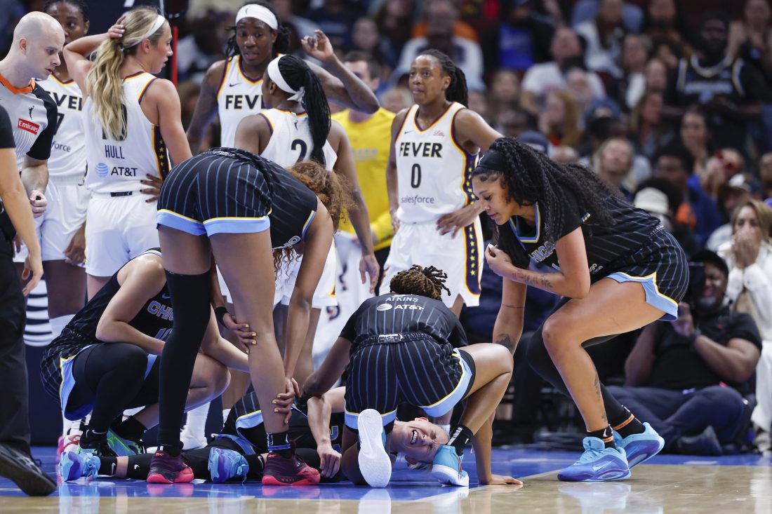 Jun 7, 2025; Chicago, Illinois, USA; Chicago Sky guard Courtney Vandersloot (22) reacts after being injured during the first half of a WNBA game against the Indiana Fever at United Center. Mandatory Credit: Kamil Krzaczynski-Imagn Images