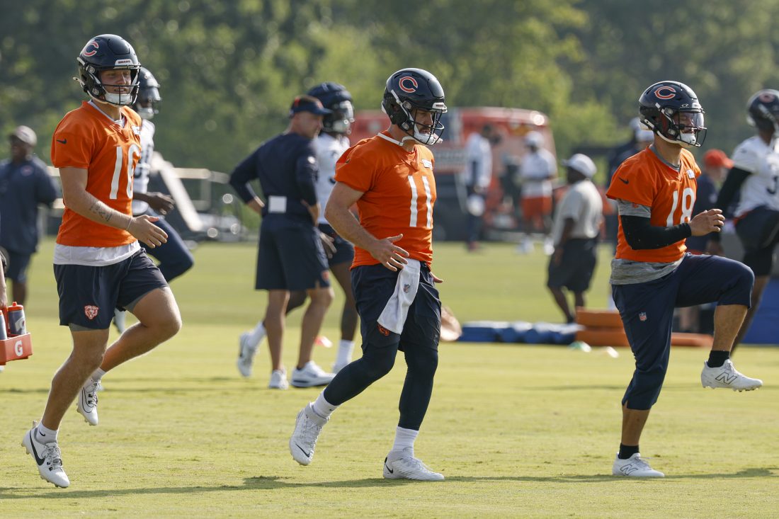 Jul 23, 2025; Lake Forest, IL, USA; Chicago Bears quarterbacks Austin Reed (16), Case Keenum (11) and Caleb Williams (18) warm up during training camp at Halas Hall. Mandatory Credit: Kamil Krzaczynski-Imagn Images
