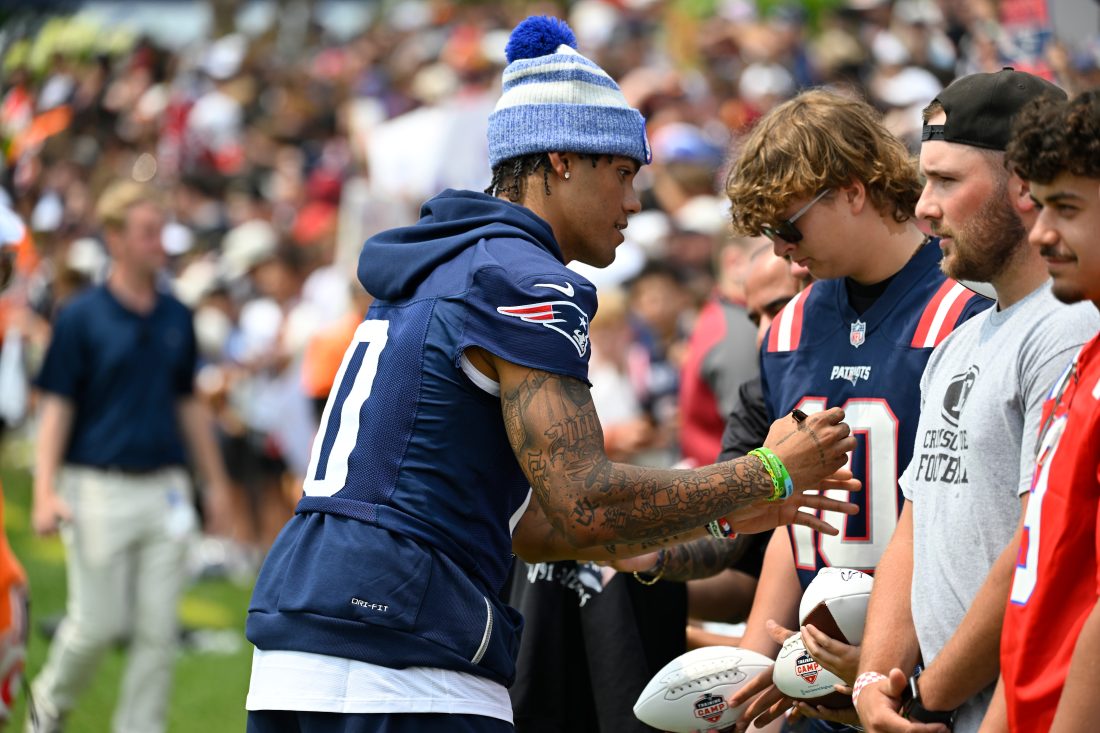 Aug 6, 2025; Foxborough, MA, USA; New England Patriots cornerback Christian Gonzalez (0) signs autographs at training camp at Gillette Stadium. Mandatory Credit: Eric Canha-Imagn Images