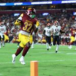 Aug 18, 2025; Landover, Maryland, USA; Washington Commanders running back Jacory Croskey-Merritt (32) scores a touchdown past Cincinnati Bengals safety Daijahn Anthony (33) during the first half at Northwest Stadium. Mandatory Credit: Amber Searls-Imagn Images