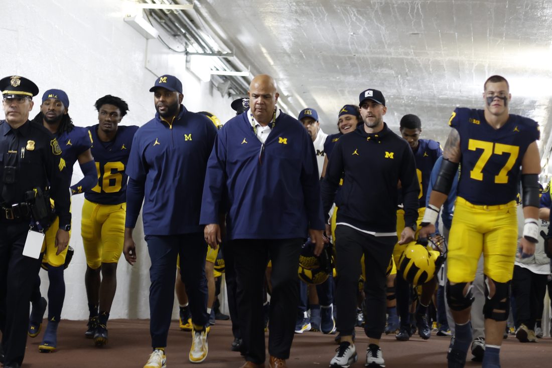 Aug 30, 2025; Ann Arbor, Michigan, USA; Michigan Wolverines head coach Sherone Moore and Athletic Director Warde Manuel lead the team up the tunnel after the game against the New Mexico Lobos at Michigan Stadium. Mandatory Credit: Rick Osentoski-Imagn Images