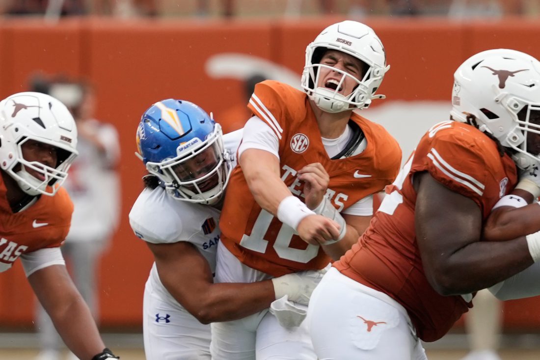 Sep 6, 2025; Austin, Texas, USA; Texas Longhorns quarterback Arch Manning (16) reacts after getting hit by San Jose State Spartans linebacker Taniela Latu (4) during the second half at Darrell K Royal-Texas Memorial Stadium. Mandatory Credit: Scott Wachter-Imagn Images