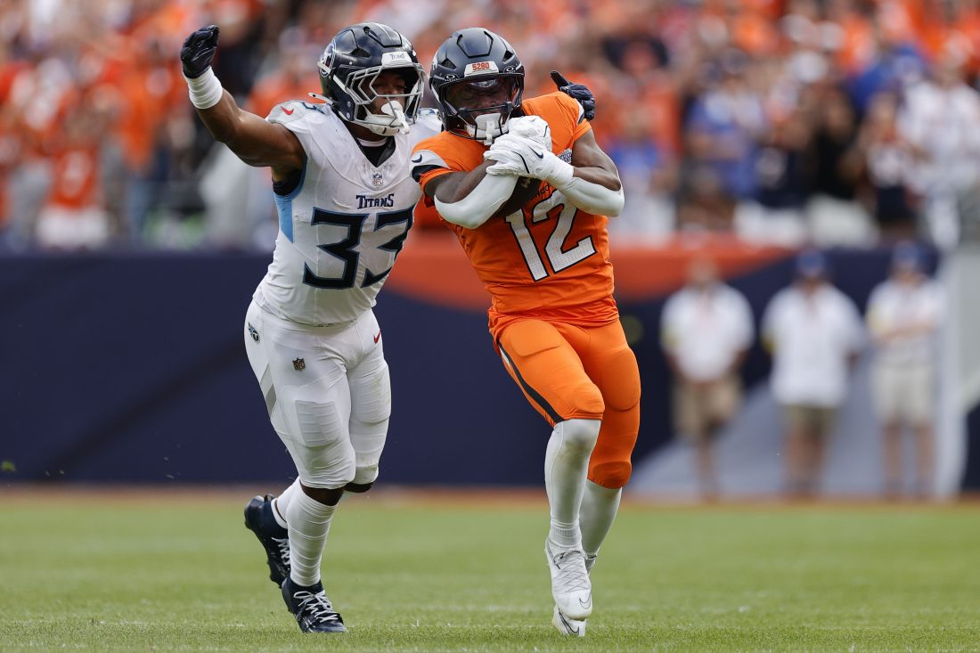Sep 7, 2025; Denver, Colorado, USA; Denver Broncos running back RJ Harvey (12) rushes the ball against the Tennessee Titans in the second half at Empower Field at Mile High. Mandatory Credit: Isaiah J. Downing-Imagn Images