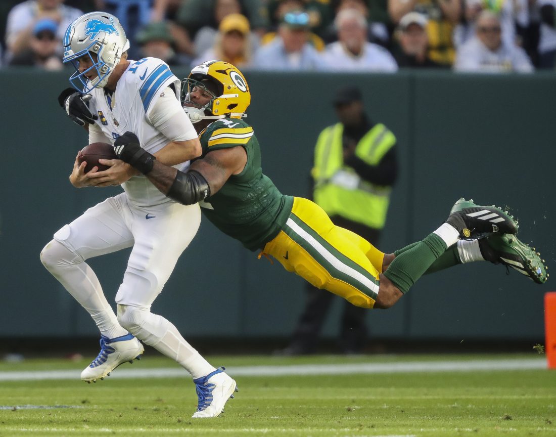 Sep 7, 2025; Green Bay, Wisconsin, USA; Green Bay Packers defensive end Micah Parsons (1) sacks Detroit Lions quarterback Jared Goff (16) during the second half at Lambeau Field. Mandatory Credit: Tork Mason-USA TODAY Network via Imagn Images