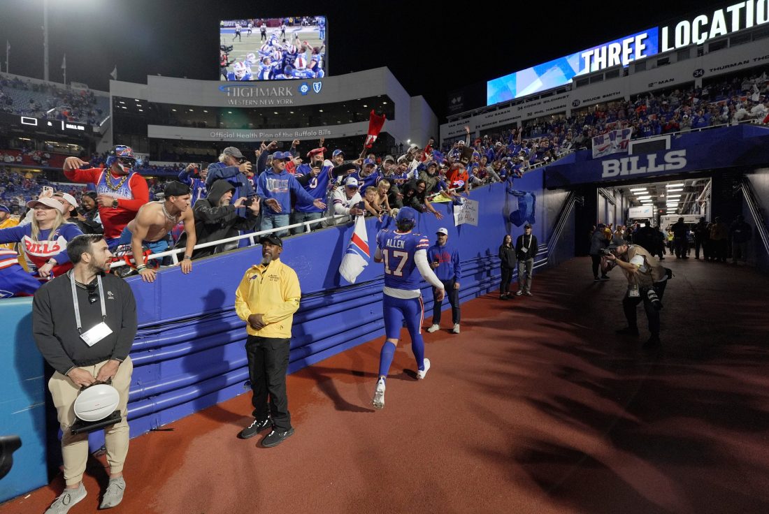 Fans wait after the game against the Baltimore Ravens and the on field interviews at Highmark Stadium in Orchard Park to get autographs and watch the players celebrate on Sept. 7, 2025. Buffalo Bills quarterback Josh Allen pauses and gives something to several boys hanging over the tunnel before he heads in.