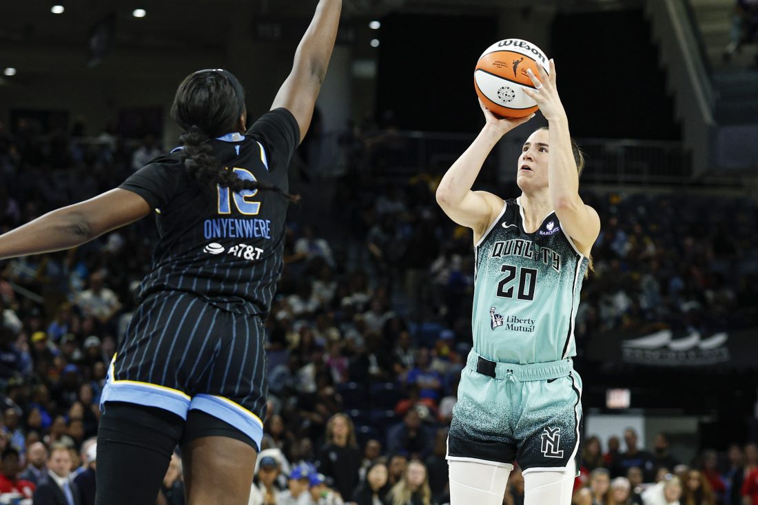 Sep 11, 2025; Chicago, Illinois, USA; New York Liberty guard Sabrina Ionescu (20) shoots against Chicago Sky forward Michaela Onyenwere (12) during the first half at Wintrust Arena. Mandatory Credit: Kamil Krzaczynski-Imagn Images