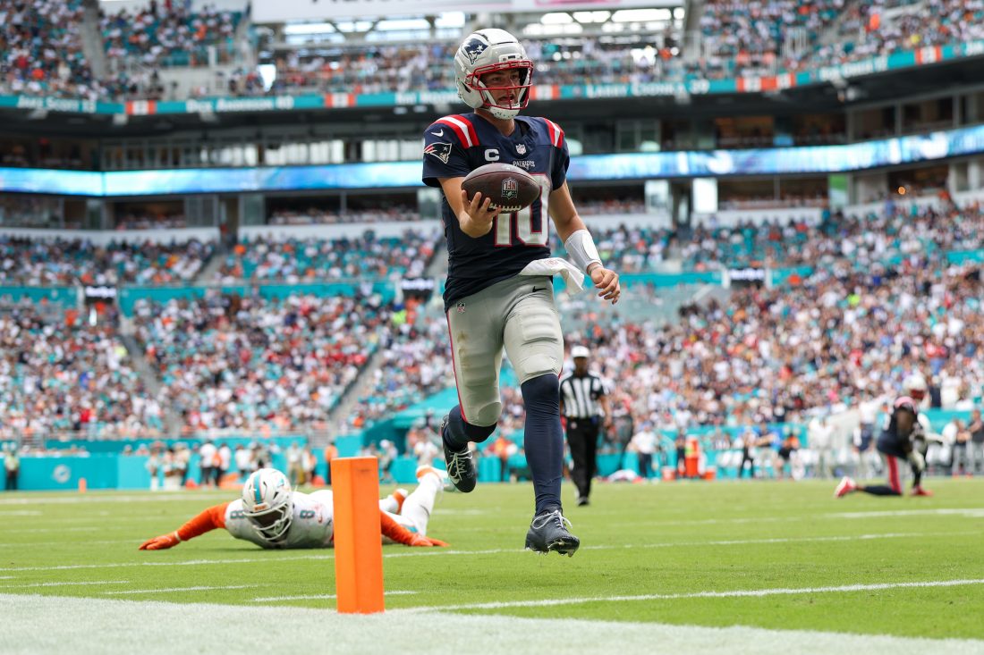 Sep 14, 2025; Miami Gardens, Florida, USA; New England Patriots quarterback Drake Maye (10) runs into the endzone for a touchdown against the Miami Dolphins in the third quarter at Hard Rock Stadium. Mandatory Credit: Nathan Ray Seebeck-Imagn Images