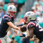 Sep 14, 2025; Miami Gardens, Florida, USA; New England Patriots running back Rhamondre Stevenson (38) takes a handoff from quarterback Drake Maye (10) against the Miami Dolphins during the third quarter at Hard Rock Stadium. Mandatory Credit: Sam Navarro-Imagn Images