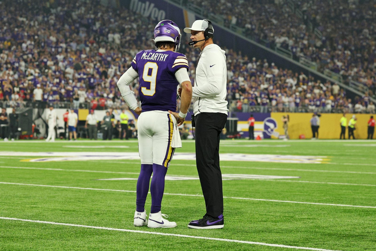 Sep 14, 2025; Minneapolis, Minnesota, USA; Minnesota Vikings quarterback J.J. McCarthy (9) speaks with Minnesota Vikings head coach Kevin O'Connell during the first half against the Atlanta Falcons at U.S. Bank Stadium. Mandatory Credit: Matt Krohn-Imagn Images