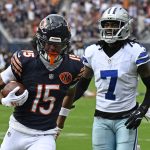 Sep 21, 2025; Chicago, Illinois, USA; Chicago Bears wide receiver Rome Odunze (15) catches a touchdown pass against Dallas Cowboys wide receiver Traeshon Holden (7) during the first half at Soldier Field.