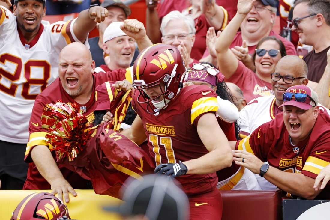 Sep 21, 2025; Landover, Maryland, USA; Washington Commanders wide receiver Luke McCaffrey (11) celebrates after scoring a touchdown during the second half against the Las Vegas Raiders at Northwest Stadium. Mandatory Credit: Amber Searls-Imagn Images