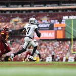 Sep 21, 2025; Landover, Maryland, USA; Las Vegas Raiders quarterback Geno Smith (7) scrambles from Washington Commanders defensive end Javontae Jean-Baptiste (90) during the fourth quarter at Northwest Stadium. Mandatory Credit: Geoff Burke-Imagn Images