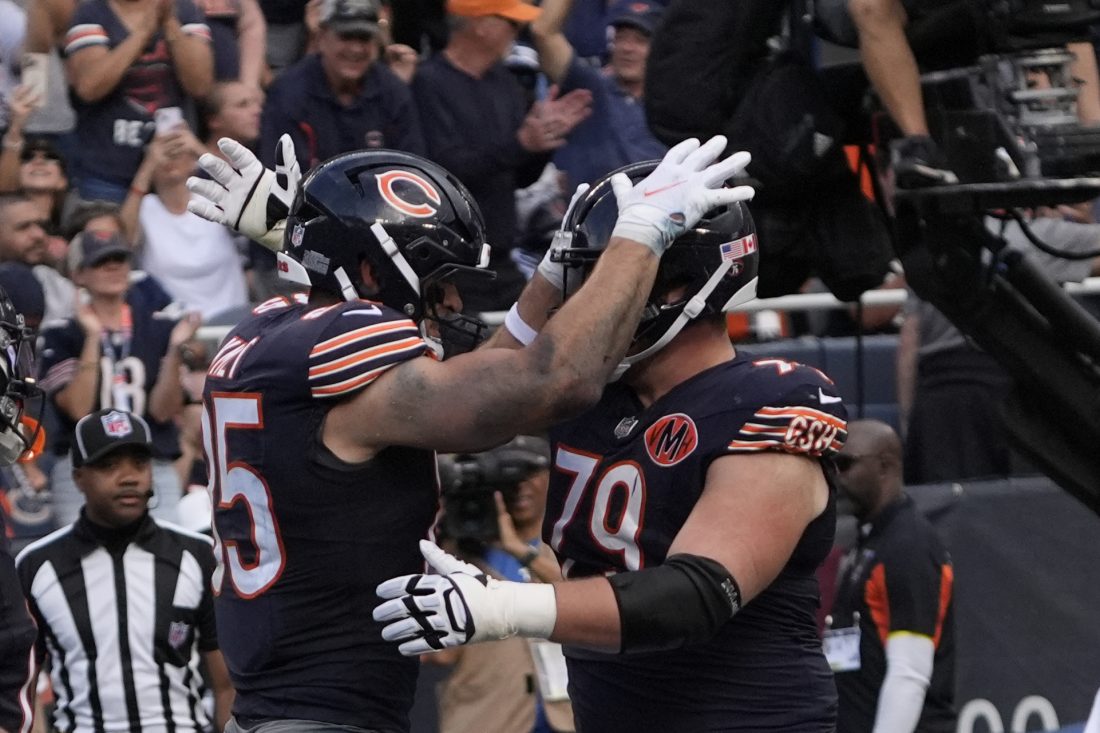 Sep 21, 2025; Chicago, Illinois, USA; Chicago Bears tight end Cole Kmet (85) celebrates his touchdown reception against the Dallas Cowboys with Chicago Bears offensive lineman Theo Benedet (79) during the first half at Soldier Field.