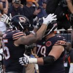 Sep 21, 2025; Chicago, Illinois, USA; Chicago Bears tight end Cole Kmet (85) celebrates his touchdown reception against the Dallas Cowboys with Chicago Bears offensive lineman Theo Benedet (79) during the first half at Soldier Field.