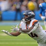 Sep 21, 2025; Inglewood, California, USA; Denver Broncos wide receiver Courtland Sutton (14) reaches for a long pass 4th down in the second half against the Los Angeles Chargers at SoFi Stadium. Mandatory Credit: Jayne Kamin-Oncea-Imagn Images