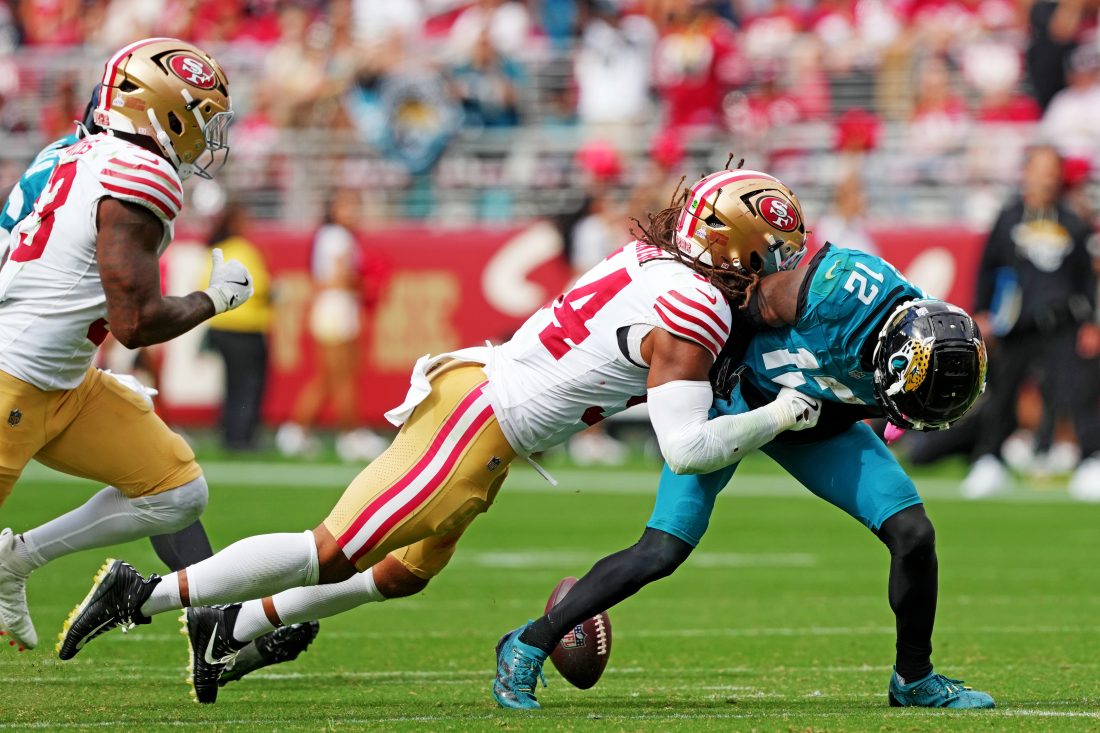 Sep 28, 2025; Santa Clara, California, USA; Jacksonville Jaguars wide receiver Travis Hunter (12) runs the ball against San Francisco 49ers linebacker Fred Warner (54) during the second half at Levi's Stadium.