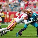 Sep 28, 2025; Santa Clara, California, USA; Jacksonville Jaguars wide receiver Travis Hunter (12) runs the ball against San Francisco 49ers linebacker Fred Warner (54) during the second half at Levi's Stadium.