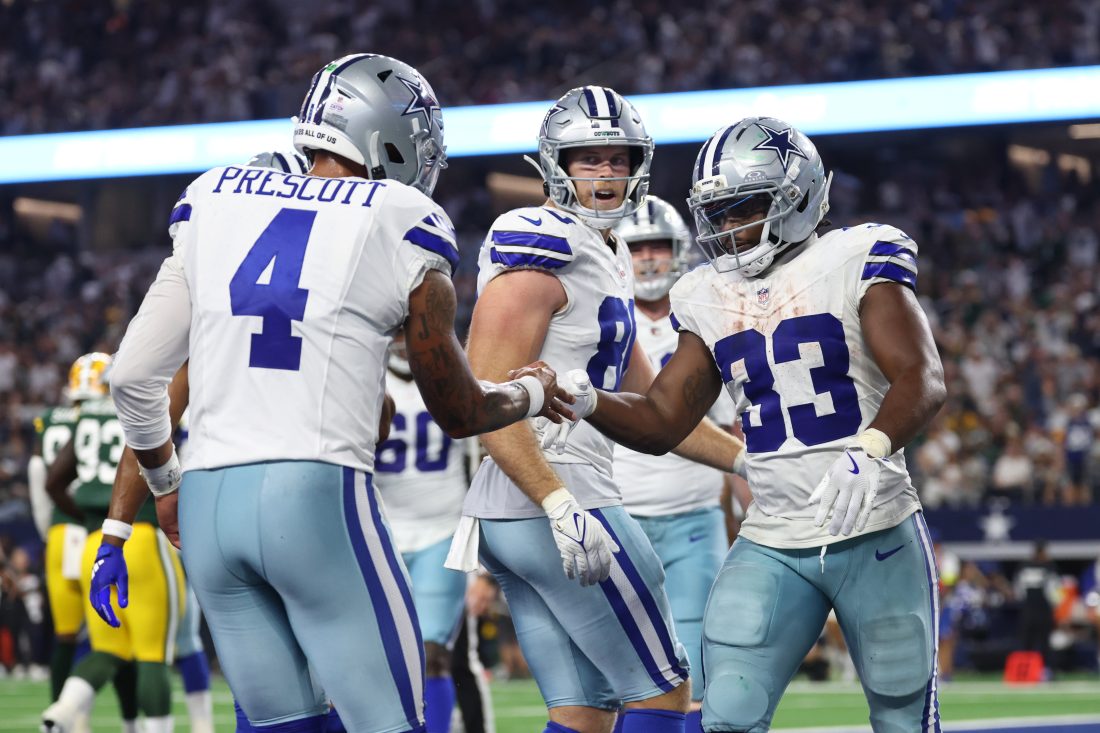 Sep 28, 2025; Arlington, Texas, USA; Dallas Cowboys running back Javonte Williams (33) celebrates with quarterback Dak Prescott (4) after scoring a touchdown against the Green Bay Packers in the fourth quarter at AT&T Stadium.
