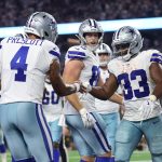 Sep 28, 2025; Arlington, Texas, USA; Dallas Cowboys running back Javonte Williams (33) celebrates with quarterback Dak Prescott (4) after scoring a touchdown against the Green Bay Packers in the fourth quarter at AT&T Stadium.