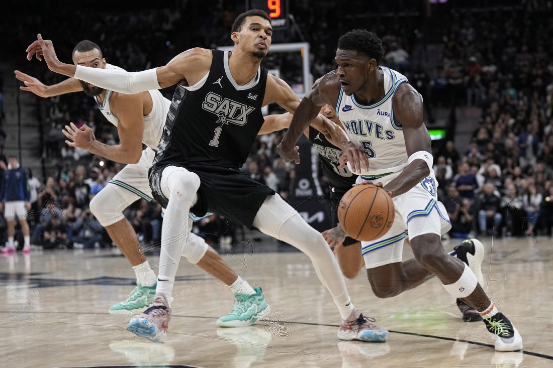 Jan 27, 2024; San Antonio, Texas, USA; Minnesota Timberwolves guard Anthony Edwards (5) drives to the basket against San Antonio Spurs forward Victor Wembanyama (1) during the second half at Frost Bank Center. Mandatory Credit: Scott Wachter-USA TODAY Sports