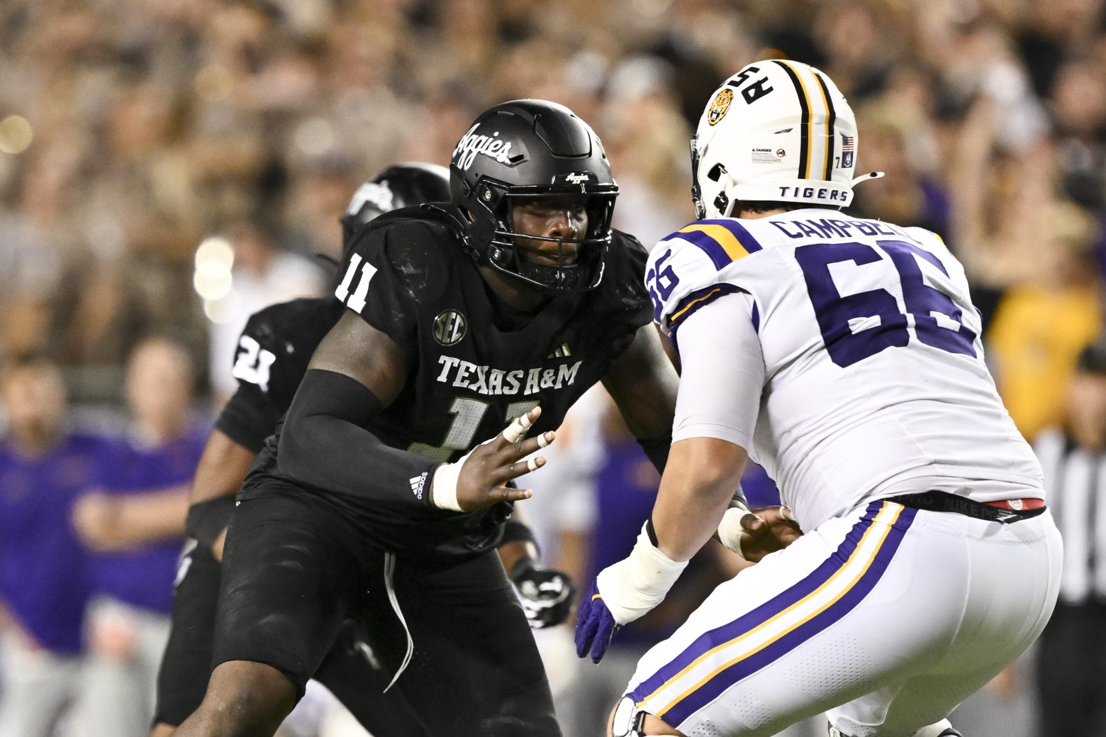 Oct 26, 2024; College Station, Texas, USA; Texas A&M Aggies defensive lineman Nic Scourton (11) defends in coverage against LSU Tigers offensive tackle Will Campbell (66) during the fourth quarter. The Aggies defeated the Tigers 38-23; at Kyle Field. Mandatory Credit: Maria Lysaker-Imagn Images.