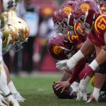 Nov 30, 2024; Los Angeles, California, USA; Helmets at the line of scrimmage as Southern California Trojans long snapper Hank Pepper (31) snaps the ball against the Notre Dame Fighting Irish in the second half at United Airlines Field at Los Angeles Memorial Coliseum. Mandatory Credit: Kirby Lee-Imagn Images