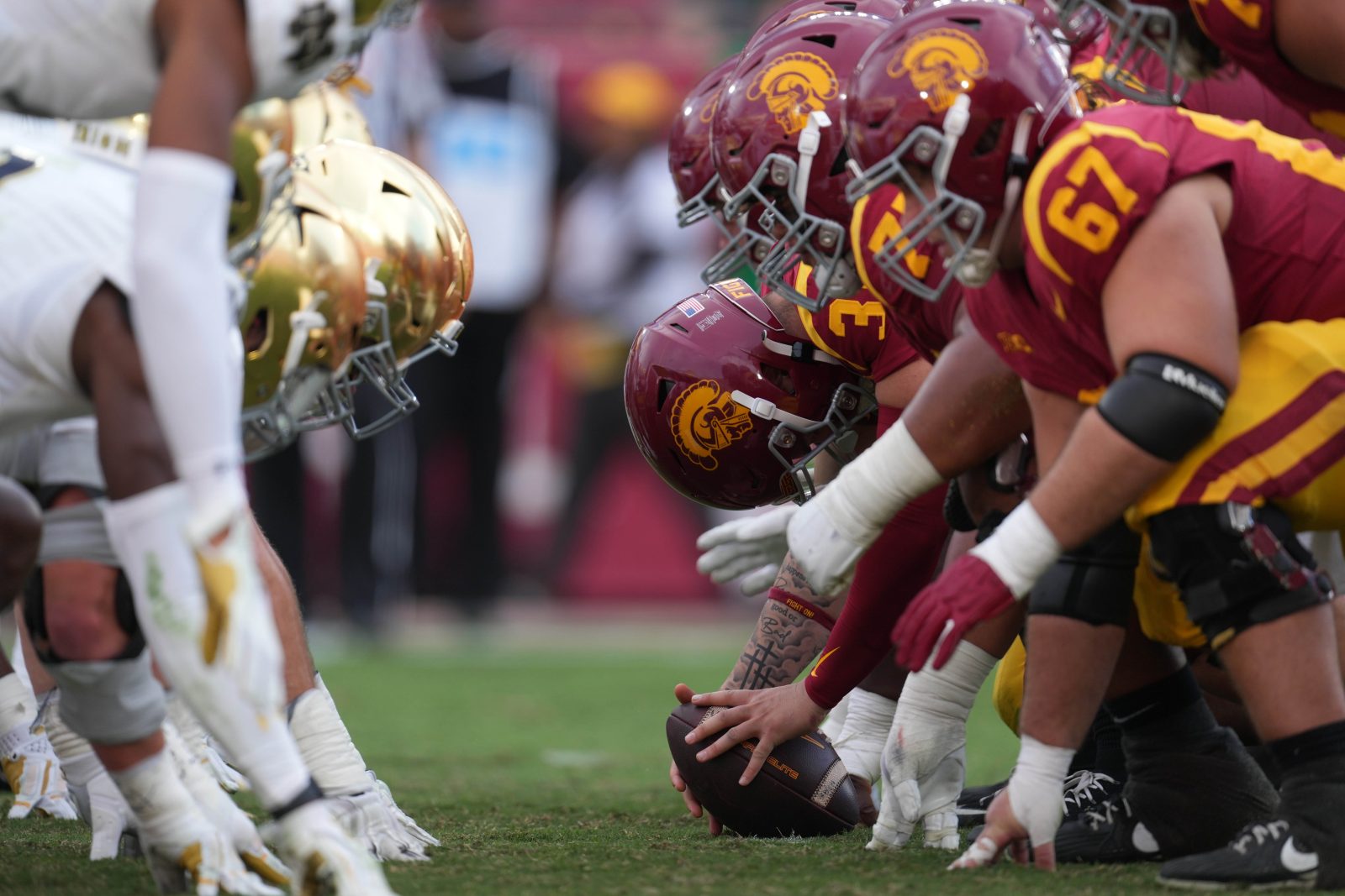 Nov 30, 2024; Los Angeles, California, USA; Helmets at the line of scrimmage as Southern California Trojans long snapper Hank Pepper (31) snaps the ball against the Notre Dame Fighting Irish in the second half at United Airlines Field at Los Angeles Memorial Coliseum. Mandatory Credit: Kirby Lee-Imagn Images