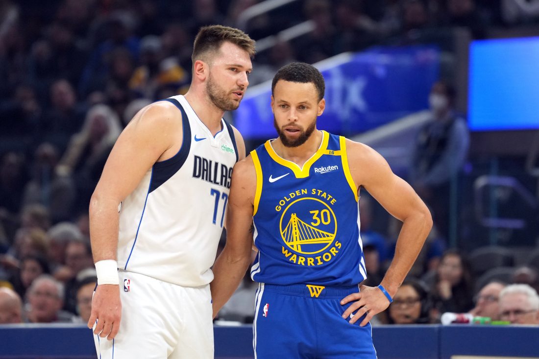 Dec 15, 2024; San Francisco, California, USA; Dallas Mavericks guard Luka Doncic (77) talks to Golden State Warriors guard Stephen Curry (30) during the first quarter at Chase Center. Mandatory Credit: Darren Yamashita-Imagn Images