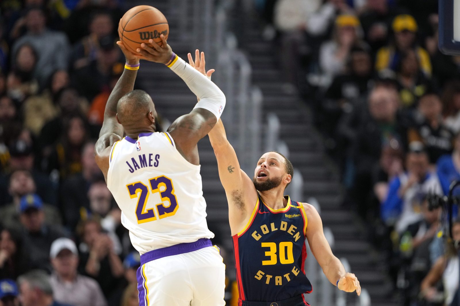 Jan 25, 2025; San Francisco, California, USA; Golden State Warriors guard Stephen Curry (30) defends against Los Angeles Lakers forward LeBron James (23) during the fourth quarter at Chase Center.