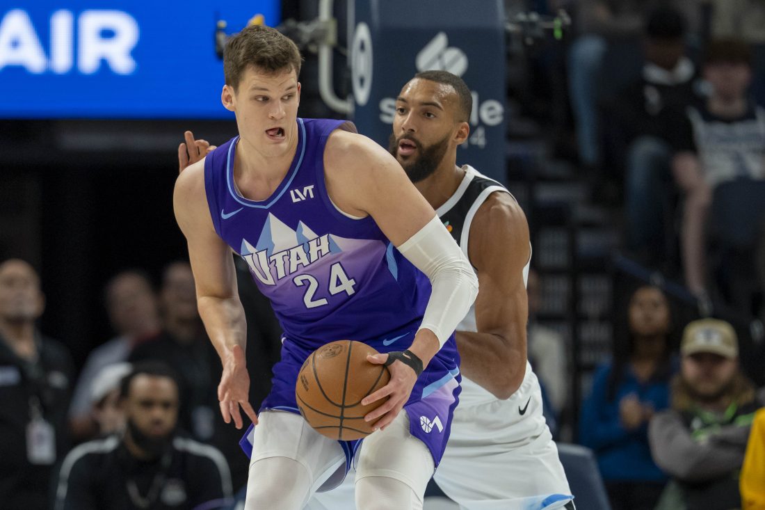 Mar 16, 2025; Minneapolis, Minnesota, USA; Utah Jazz center Walker Kessler (24) backs towards the basket as Minnesota Timberwolves center Rudy Gobert (27) plays defense in the first half at Target Center. Mandatory Credit: Jesse Johnson-Imagn Images