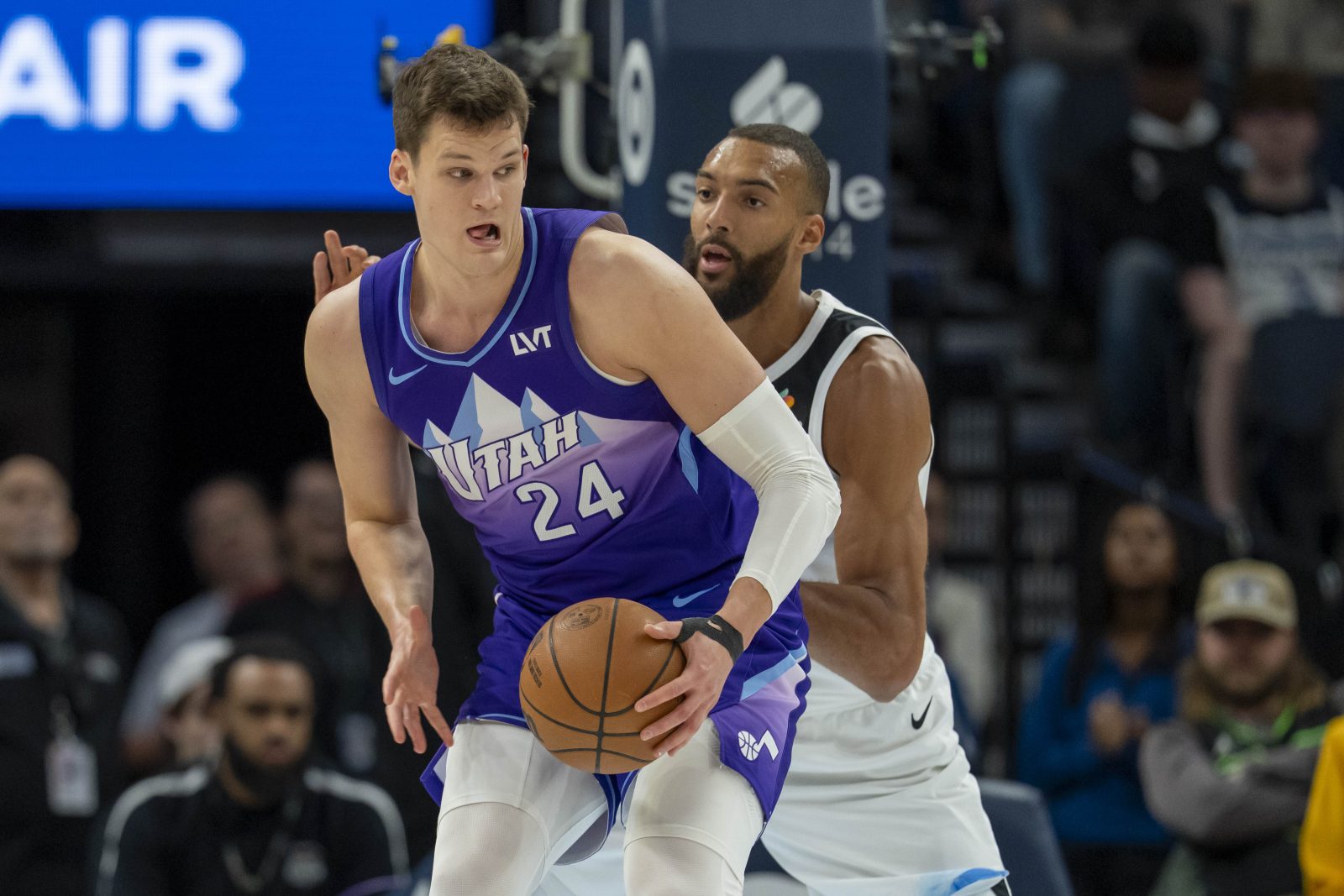 Mar 16, 2025; Minneapolis, Minnesota, USA; Utah Jazz center Walker Kessler (24) backs towards the basket as Minnesota Timberwolves center Rudy Gobert (27) plays defense in the first half at Target Center. Mandatory Credit: Jesse Johnson-Imagn Images