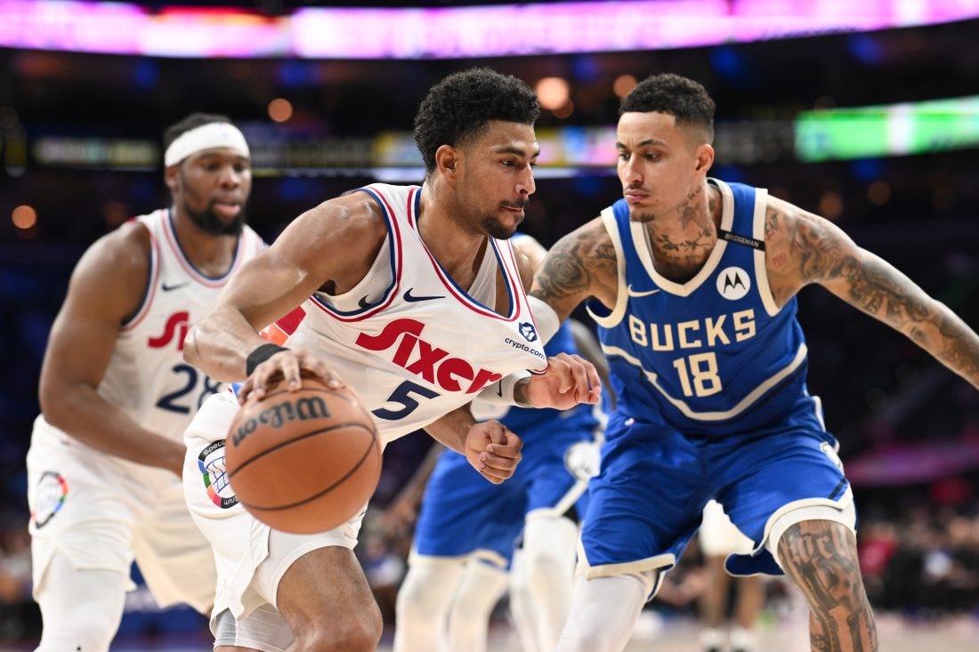Apr 3, 2025; Philadelphia, Pennsylvania, USA; Philadelphia 76ers guard Quentin Grimes (5) drives against Milwaukee Bucks forward Kyle Kuzma (18) in the fourth quarter at Wells Fargo Center.