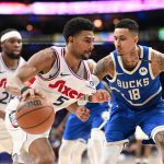Apr 3, 2025; Philadelphia, Pennsylvania, USA; Philadelphia 76ers guard Quentin Grimes (5) drives against Milwaukee Bucks forward Kyle Kuzma (18) in the fourth quarter at Wells Fargo Center.