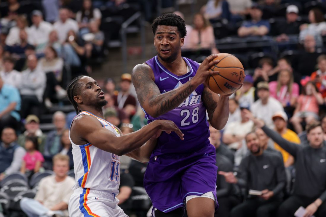 Apr 11, 2025; Salt Lake City, Utah, USA; Utah Jazz forward Brice Sensabaugh (28) tries to get away from Oklahoma City Thunder forward Adam Flagler (14) during the second half at Delta Center. Mandatory Credit: Chris Nicoll-Imagn Images