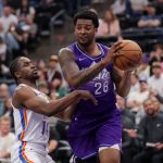 Apr 11, 2025; Salt Lake City, Utah, USA; Utah Jazz forward Brice Sensabaugh (28) tries to get away from Oklahoma City Thunder forward Adam Flagler (14) during the second half at Delta Center. Mandatory Credit: Chris Nicoll-Imagn Images