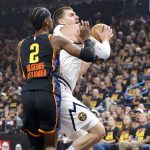 May 5, 2025; Oklahoma City, Oklahoma, USA; Denver Nuggets center Nikola Jokic (15) drives against Oklahoma City Thunder guard Shai Gilgeous-Alexander (2) during the first quarter in game one of the second round for the 2025 NBA Playoffs at Paycom Center.