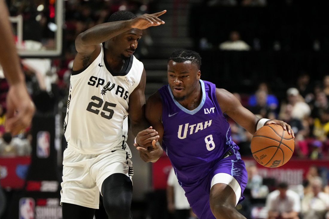 Jul 14, 2025; Las Vegas, NV, USA; Utah Jazz guard Isaiah Collier (8) drives the ball against San Antonio Spurs forward David Jones-Garcia (25) during the first half of a NBA basketball game at the Thomas & Mack Center.