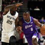 Jul 14, 2025; Las Vegas, NV, USA; Utah Jazz guard Isaiah Collier (8) drives the ball against San Antonio Spurs forward David Jones-Garcia (25) during the first half of a NBA basketball game at the Thomas & Mack Center.