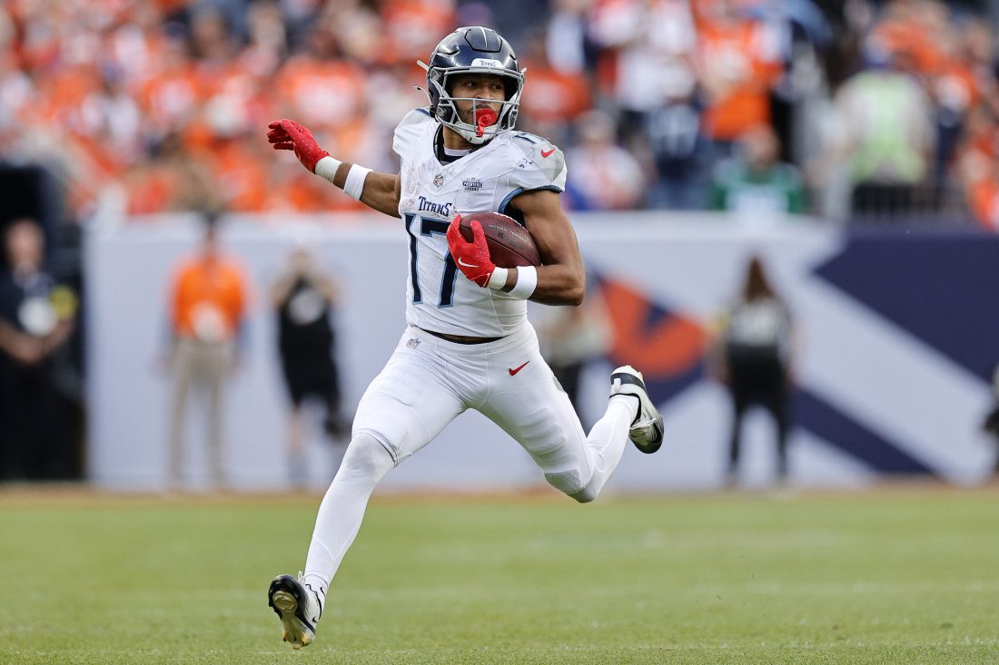 Sep 7, 2025; Denver, Colorado, USA; Tennessee Titans wide receiver Chimere Dike (17) runs with the ball against the Denver Broncos in the first half at Empower Field at Mile High. Mandatory Credit: Isaiah J. Downing-Imagn Images