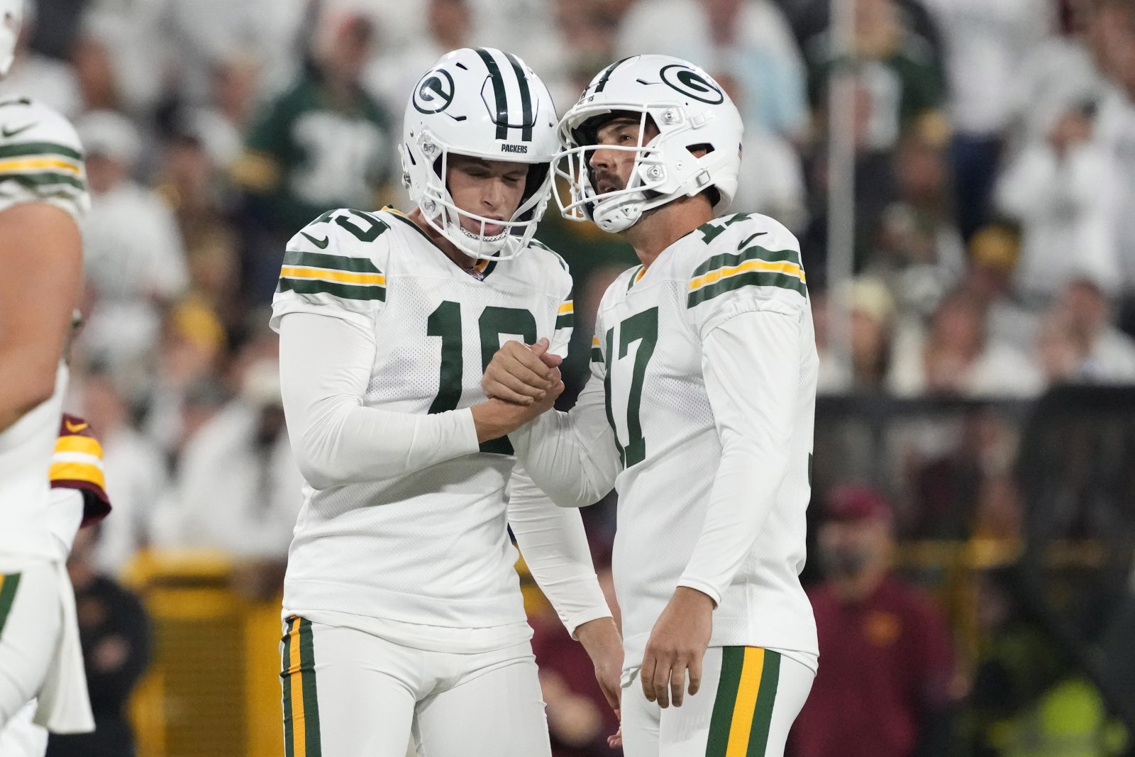Sep 11, 2025; Green Bay, Wisconsin, USA; Green Bay Packers place kicker Brandon McManus (17) reacts with punter Daniel Whelan (19) after a field goal in the fourth quarter against the Washington Commanders at Lambeau Field. Mandatory Credit: Jeff Hanisch-Imagn Images
