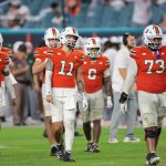 Sep 20, 2025; Miami Gardens, Florida, USA; Miami Hurricanes quarterback Carson Beck (11) and his teammates walk toward the line of scrimmage against the Florida Gators during the fourth quarter at Hard Rock Stadium. Mandatory Credit: Sam Navarro-Imagn Images