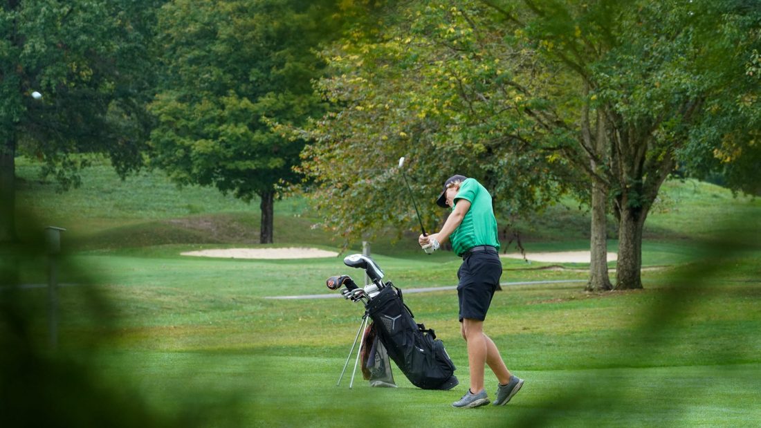 Harrison's Ryan Mullins swings through his approach shot at the Division I boys golf sectional tournament at Miami Whitewater Golf Course on Sept. 24, 2025.