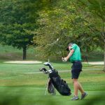 Harrison's Ryan Mullins swings through his approach shot at the Division I boys golf sectional tournament at Miami Whitewater Golf Course on Sept. 24, 2025.