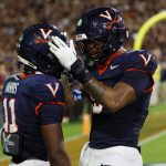 Sep 26, 2025; Charlottesville, Virginia, USA; Virginia Cavaliers wide receiver Trell Harris (11) celebrates with Cavaliers tight end Dakota Twitty (9) after catches a two point conversion as Florida State Seminoles defensive back Jerry Wilson (19) defends in the second overtime period at Scott Stadium. Mandatory Credit: Geoff Burke-Imagn Images